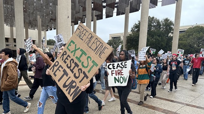 Students at the University of Texas at San Antonio march through the Sombrilla plaza at the school's main campus Thursday.