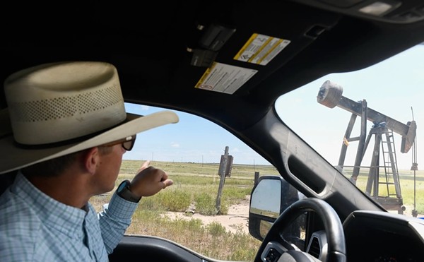 Craig Cowden points to a pump jack on his Breezy Point Ranch in Pampa on July 7. Cowden said he often spots problems with oilfield electrical equipment such as a pumpjack with faulty wiring or a power line lying on dead grass.